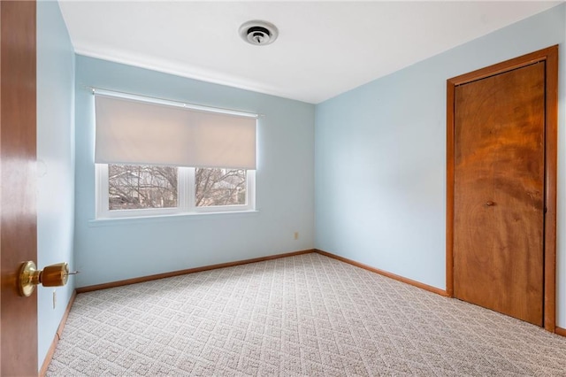 empty room with light colored carpet