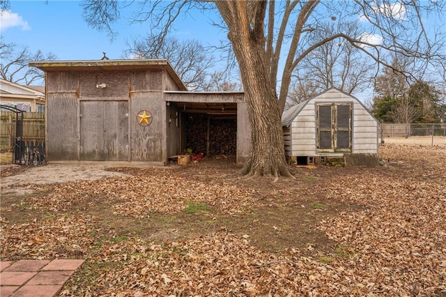 rear view of property featuring a storage shed