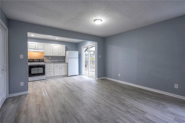 kitchen featuring range with electric stovetop, white cabinets, white refrigerator, and light hardwood / wood-style floors