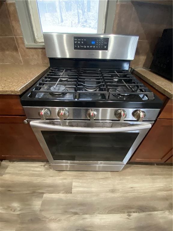 room details with decorative backsplash and stainless steel gas range