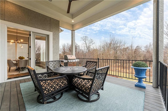 deck with ceiling fan, area for grilling, and outdoor dining space