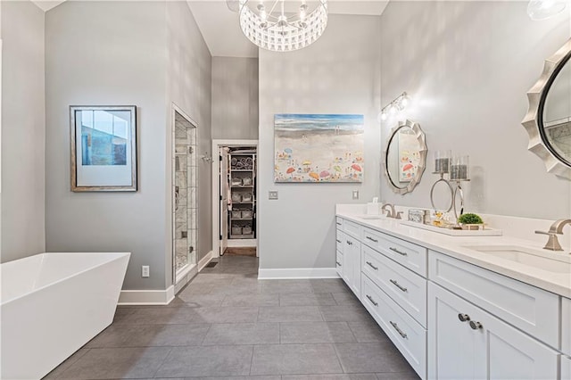 full bathroom with a stall shower, baseboards, and a sink