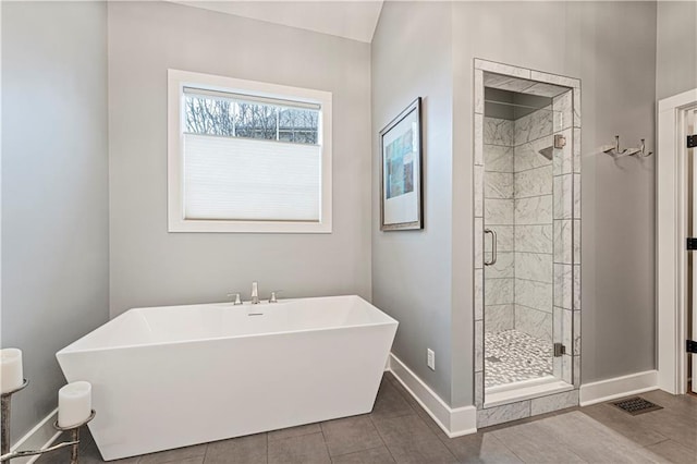 bathroom with baseboards, visible vents, a soaking tub, a stall shower, and tile patterned floors