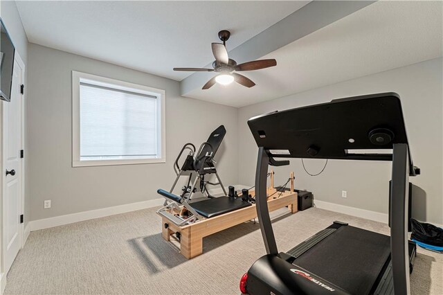 workout area featuring a ceiling fan, carpet, and baseboards