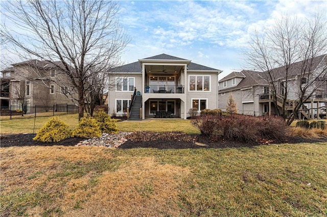 back of property featuring a lawn, a ceiling fan, fence, stairs, and a patio area