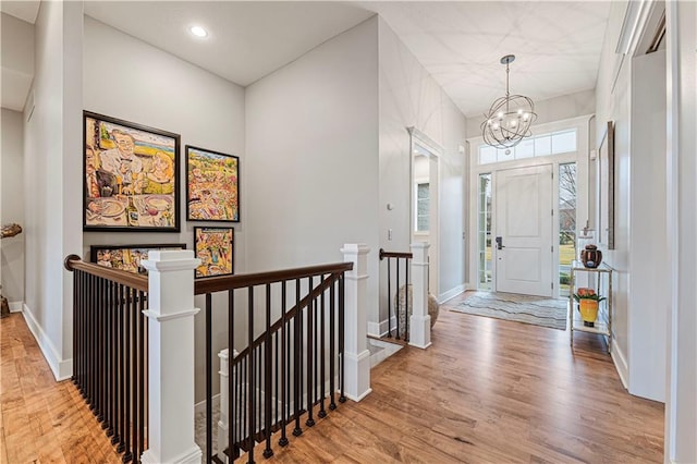 foyer with a chandelier, recessed lighting, baseboards, and wood finished floors