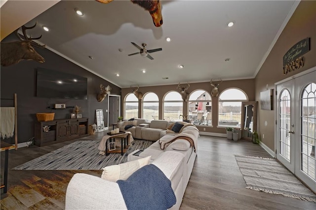 living room with french doors, lofted ceiling, crown molding, and wood-type flooring