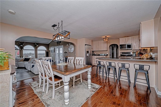 dining area featuring dark hardwood / wood-style floors and a textured ceiling