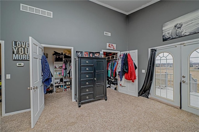 interior space with french doors, carpet flooring, a spacious closet, and access to exterior