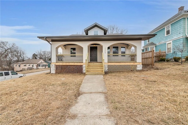 bungalow-style house featuring a porch and a front lawn