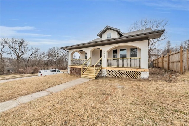 view of front of home featuring a front yard and covered porch