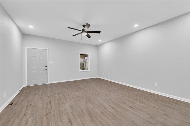 empty room with wood finished floors, visible vents, baseboards, recessed lighting, and ceiling fan