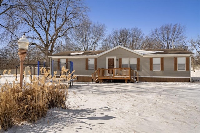 view of snow covered back of property