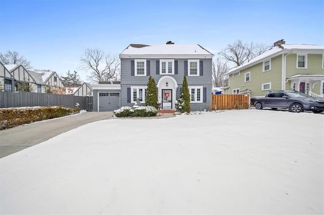 view of front of property with a residential view, concrete driveway, fence, and an attached garage