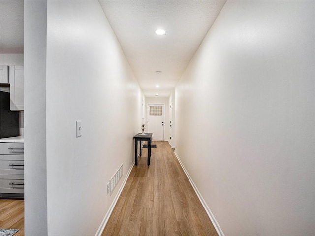 hall with light wood-type flooring