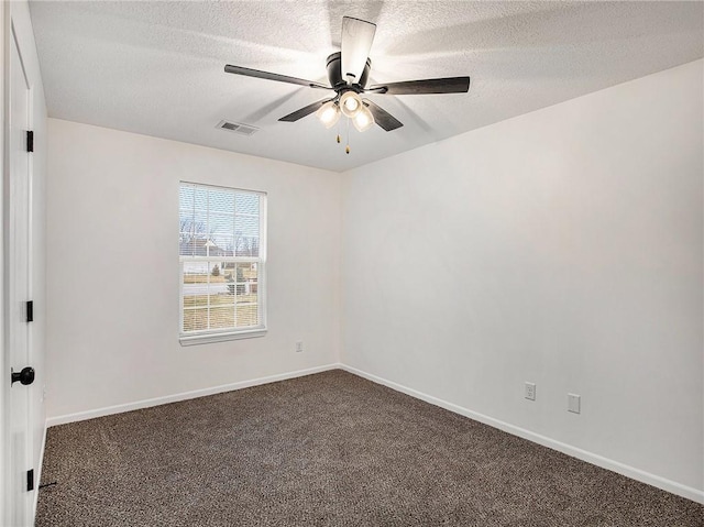 carpeted empty room featuring a textured ceiling and ceiling fan