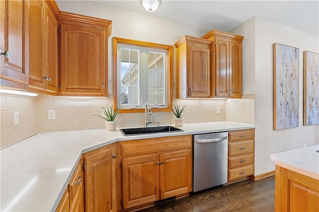 kitchen featuring dark wood-style floors, tasteful backsplash, a sink, light stone countertops, and dishwasher