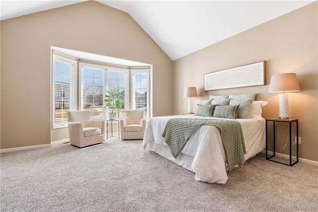 carpeted bedroom with lofted ceiling and baseboards