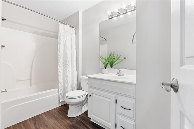 bathroom featuring toilet, shower / bath combination with curtain, wood finished floors, and vanity