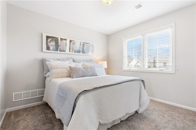 carpeted bedroom with baseboards and visible vents