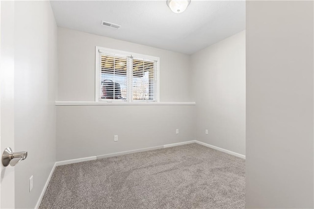 spare room featuring baseboards, visible vents, and carpet flooring