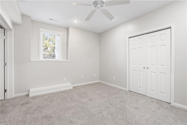 unfurnished bedroom featuring ceiling fan, carpet floors, a closet, and baseboards