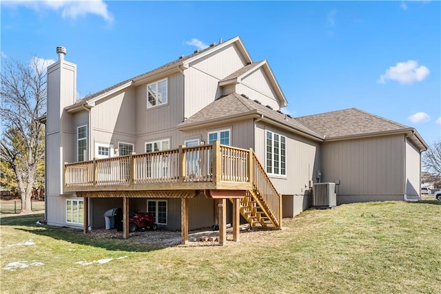 rear view of property with a yard, a chimney, a wooden deck, and stairs