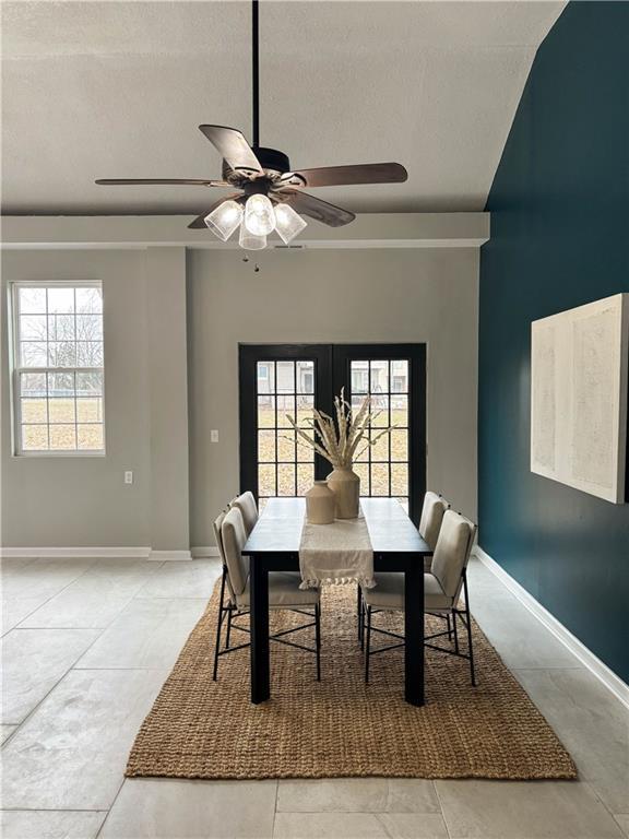 dining room with ceiling fan and a textured ceiling