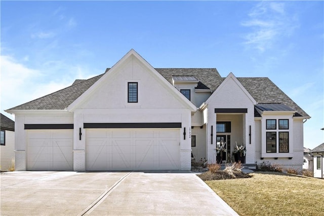 modern inspired farmhouse featuring a standing seam roof, concrete driveway, and brick siding