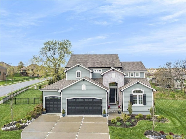 view of front of home with a garage, concrete driveway, a front lawn, and fence