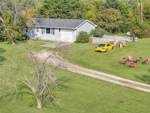 view of yard with a garage and driveway