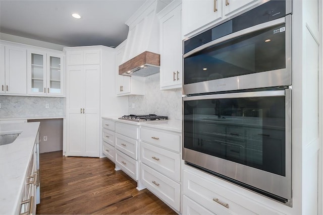 kitchen featuring white cabinetry, appliances with stainless steel finishes, backsplash, and dark hardwood / wood-style flooring