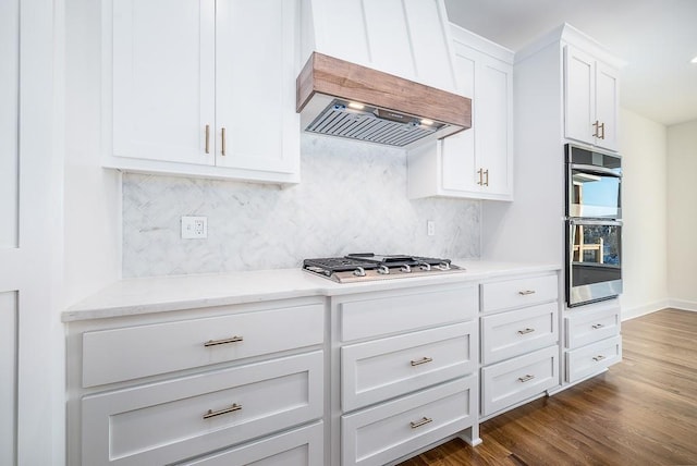 kitchen with white cabinetry, appliances with stainless steel finishes, dark hardwood / wood-style floors, and custom range hood