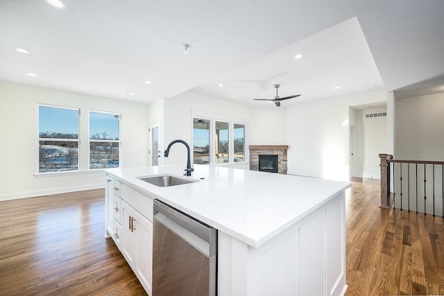 kitchen featuring white cabinetry, dishwasher, sink, and a center island with sink