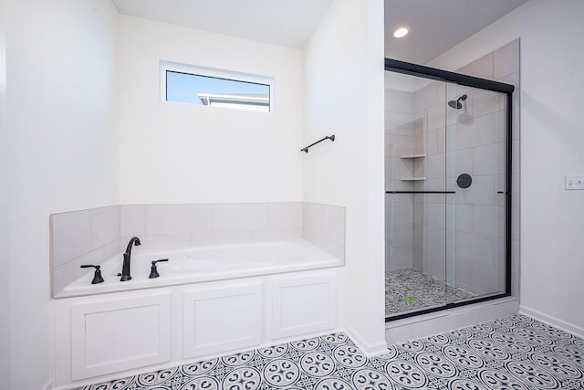 bathroom featuring tile patterned flooring and shower with separate bathtub