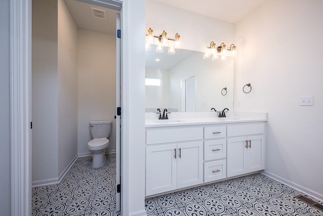 bathroom featuring vanity, tile patterned floors, and toilet