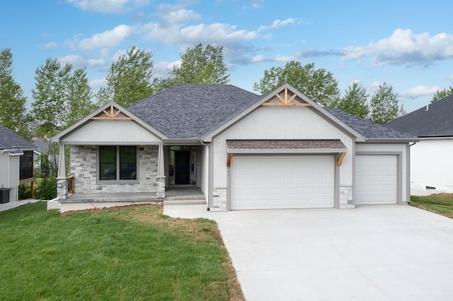 view of front of house featuring a garage, covered porch, and a front lawn