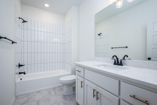 full bathroom with tiled shower / bath combo, vanity, tile patterned floors, and toilet