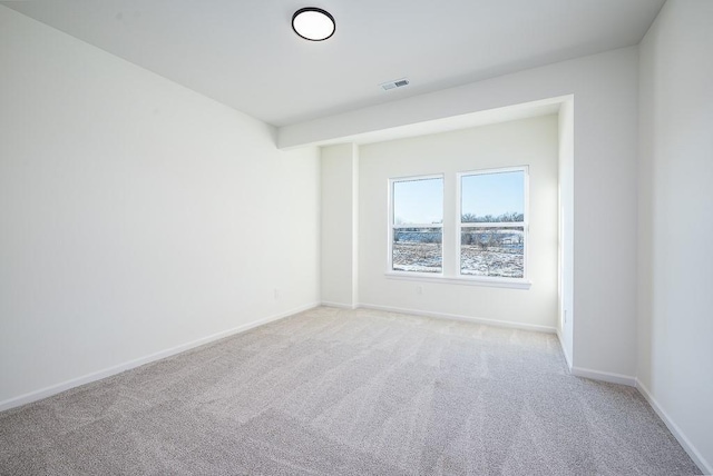 spare room featuring light colored carpet