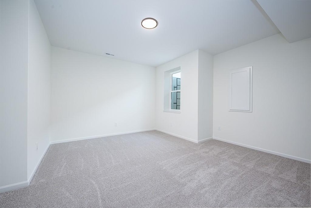 spare room featuring light colored carpet