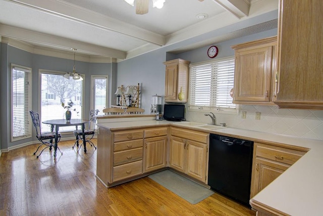 kitchen with light hardwood / wood-style flooring, beam ceiling, black dishwasher, light brown cabinets, and pendant lighting