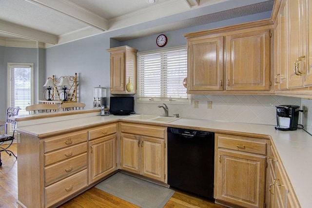 kitchen featuring kitchen peninsula, beam ceiling, sink, dishwasher, and decorative backsplash