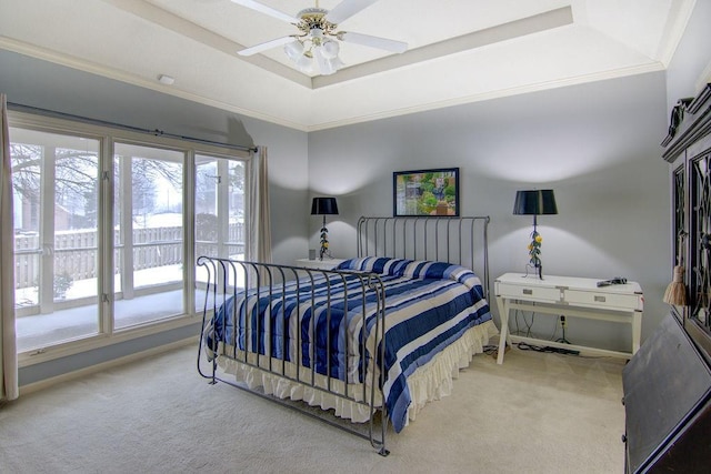 bedroom with ornamental molding, carpet flooring, ceiling fan, and a raised ceiling