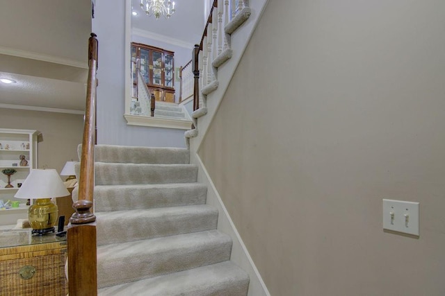 stairway with carpet floors and ornamental molding