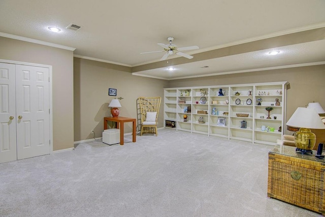 living area with carpet floors, ornamental molding, and ceiling fan