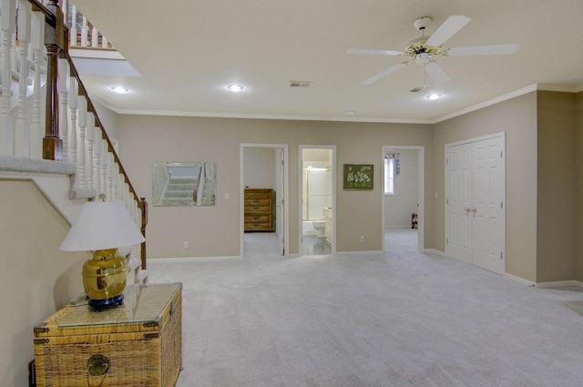 interior space with ornamental molding and ceiling fan