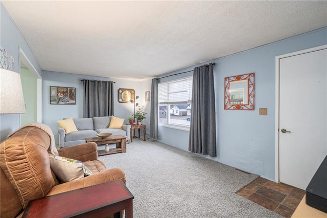 carpeted living room with a textured ceiling