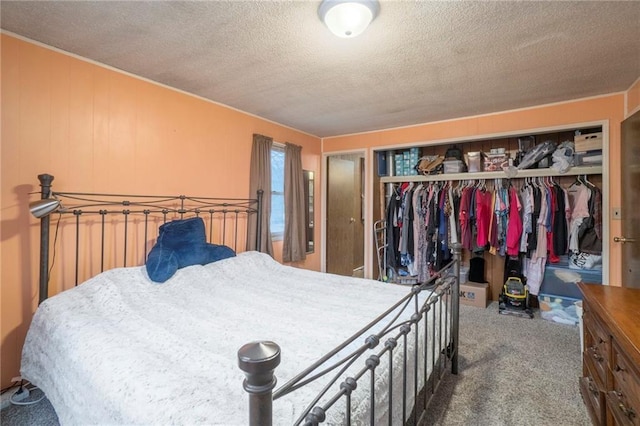 carpeted bedroom featuring a closet and a textured ceiling