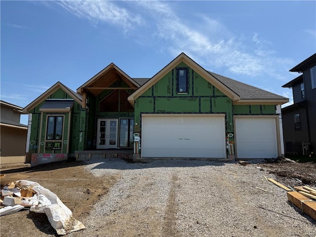 property under construction with french doors and driveway