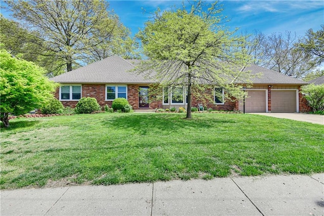 ranch-style house with brick siding, a front yard, concrete driveway, and an attached garage